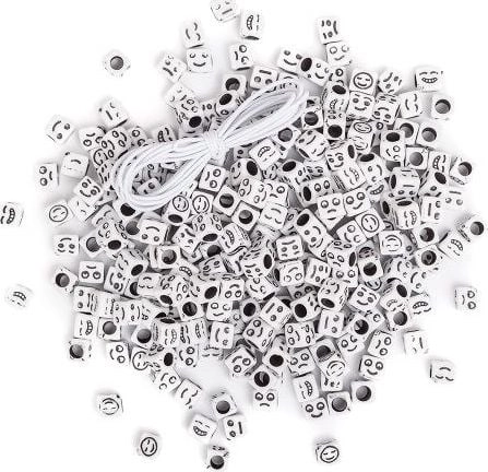 Black emoticon beads on a white