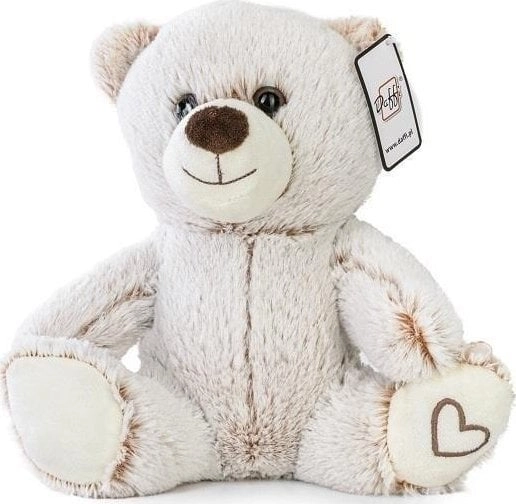 A beige teddy bear sitting with